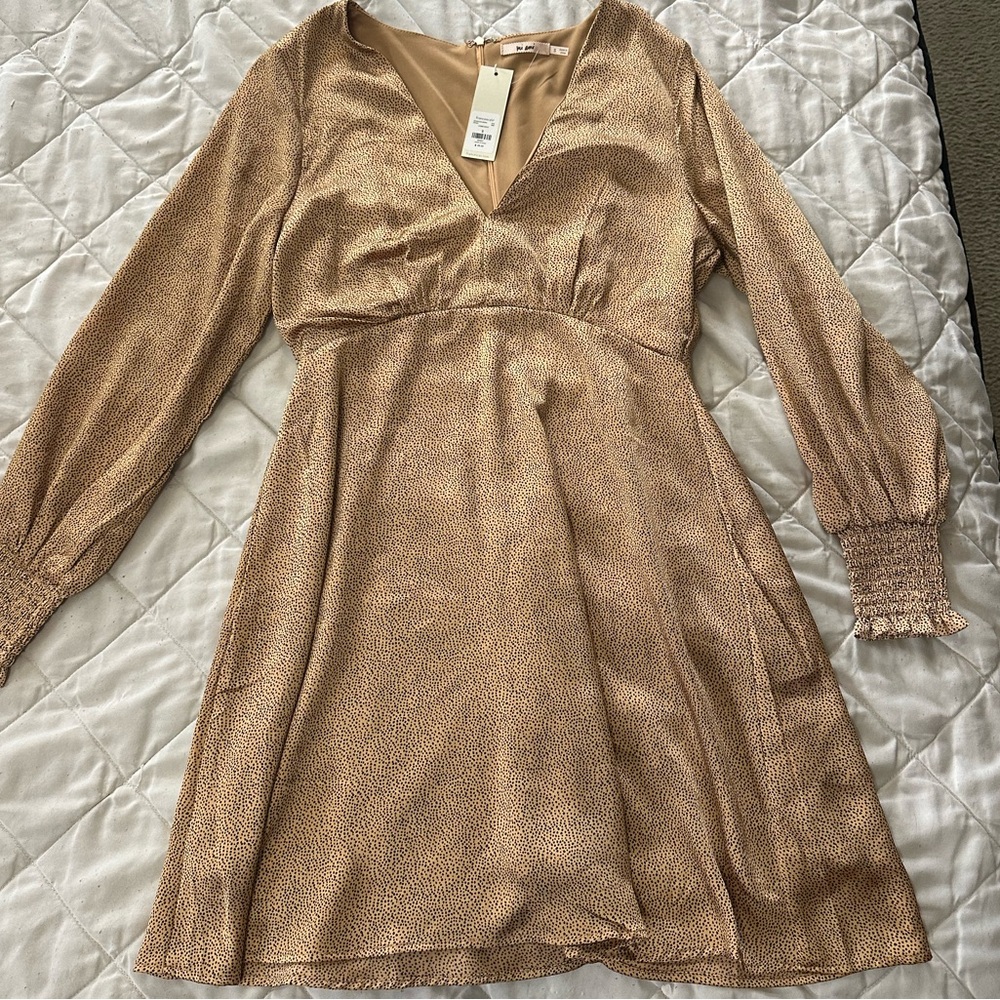 Gold silky dress with black design and cinched long sleeves